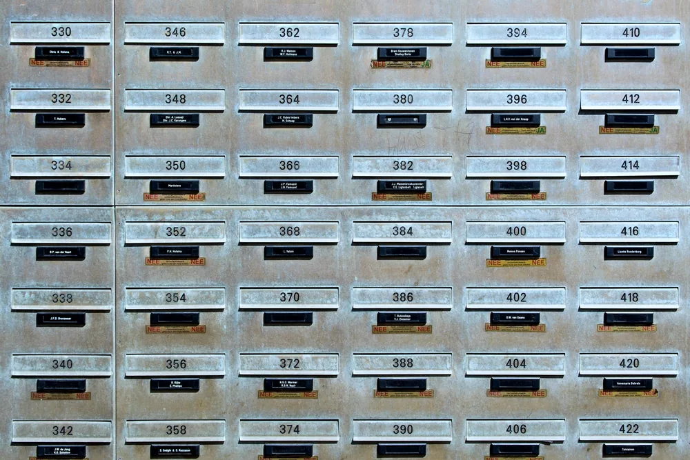 Rows of numbered industrial metal mailboxes